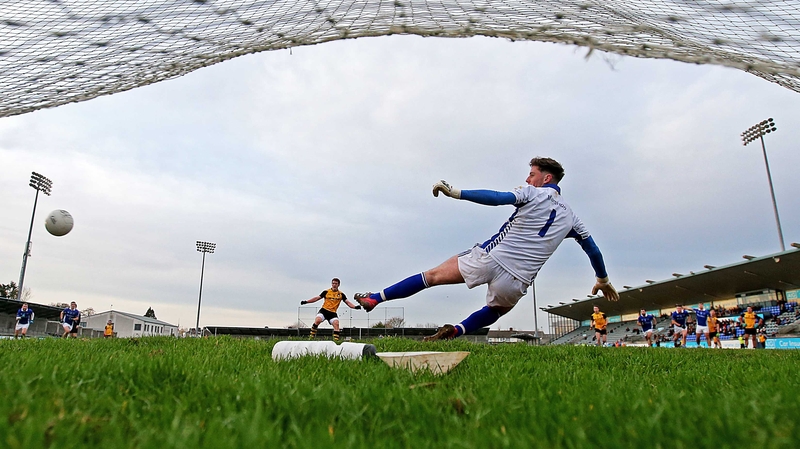Ulster's Peter Harte scores a penalty past Munster goalkeeper Evan Comerford in their semi-final