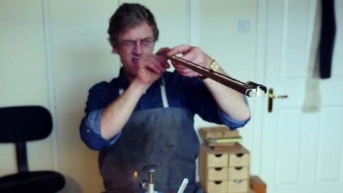 Irish violin bow-maker Gary Leahy tests the camber on his latest creation