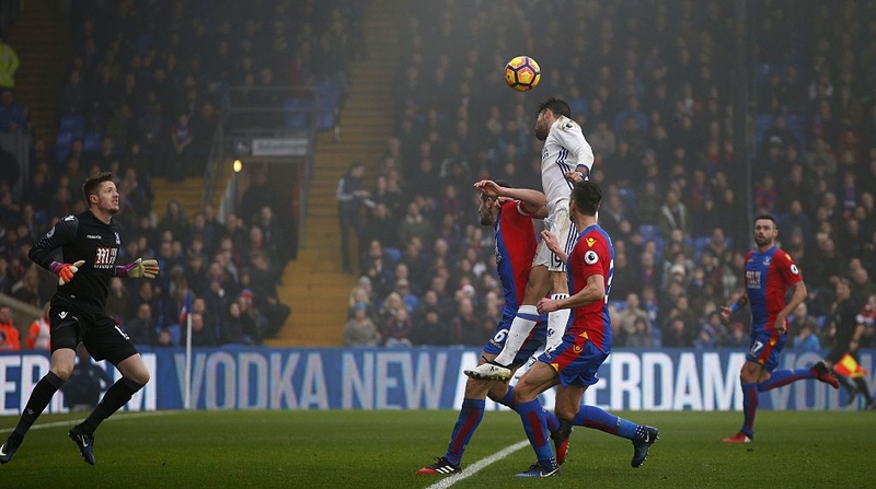 Diego Costa (C) jumps to score for Chelsea