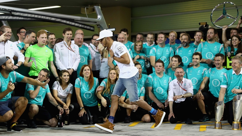 Lewis Hamilton runs from the team celebration before the champagne is sprayed at the Abu Dhabi GP