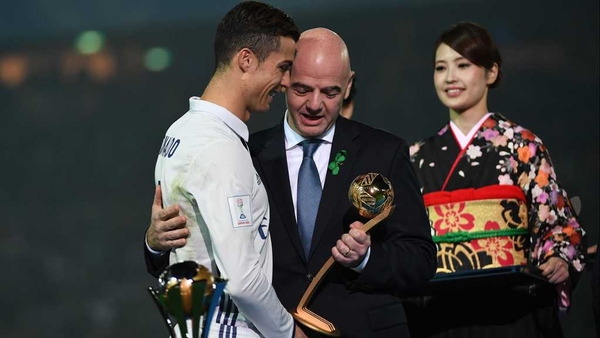 Cristiano Ronaldo receives the Golden Ball award from Gianni Infantino