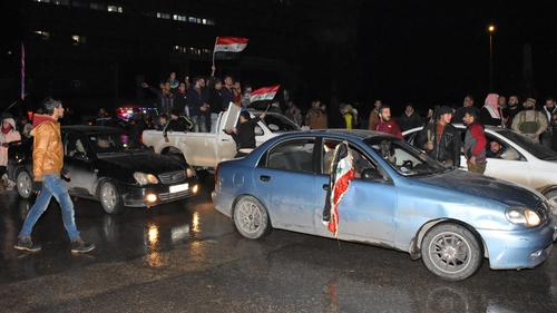 Residents celebrate on the streets in Aleppo