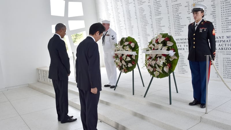 Barack Obama (left) and Shinzo Abe place wreaths at the USS Arizona Memorial at Pearl Harbor