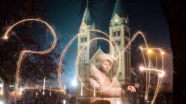 A woman writes 2017 using a sparkler during celebrations in Nyiregyhaza, 245km east of Budapest