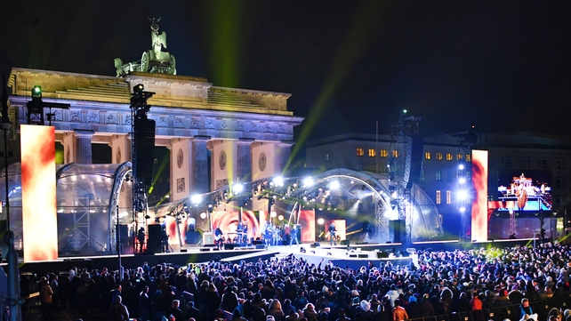 Revellers wait for the start of a New Year concert celebration near Berlin's Brandenburg Gate