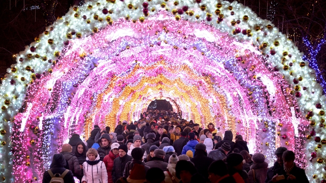 People walk past Christmas decorations in central Moscow
