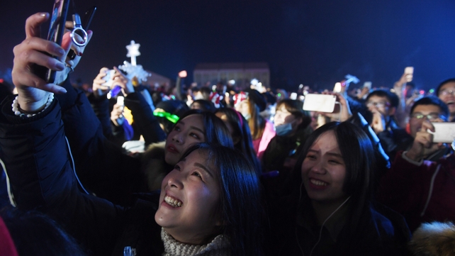 Women pose for a selfie during New Year celebrations in Beijing