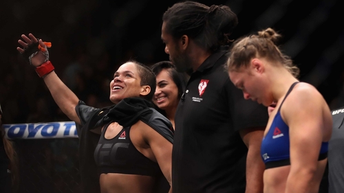 Ronda Rousey (R) hangs her head in defeat