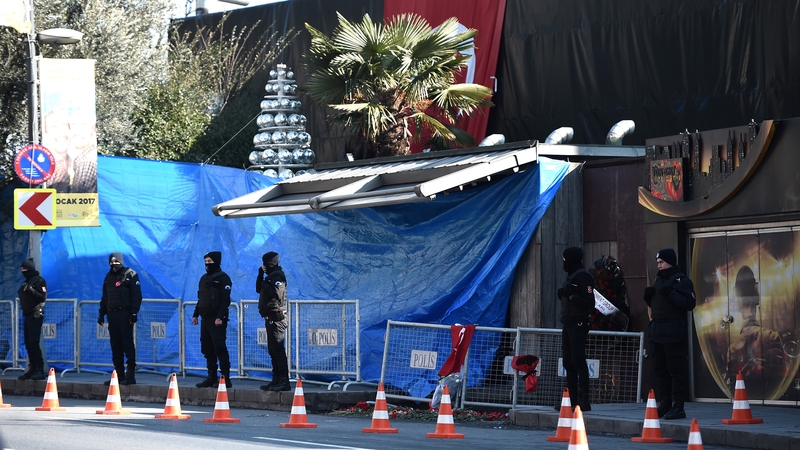 Police stand guard outside the scene of the attack