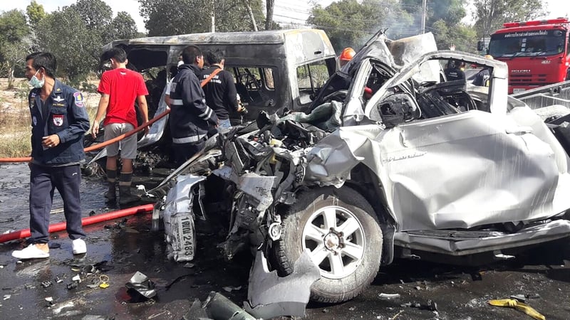 Thai rescue workers inspect the vehicles after the crash
