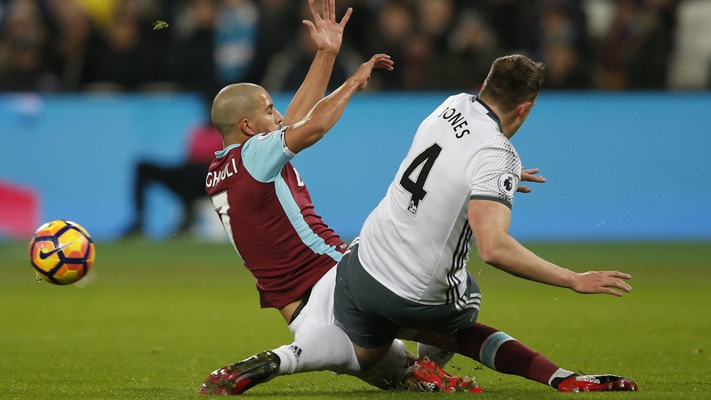 Sofiane Feghouli and Phil Jones clash