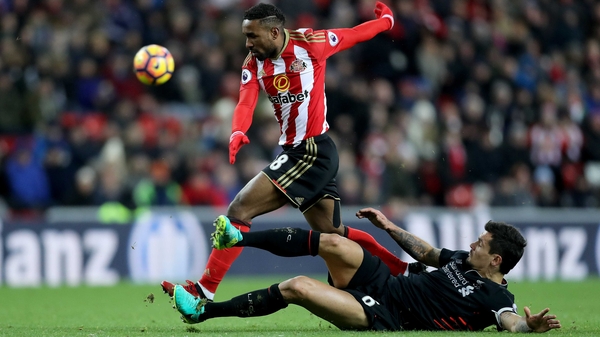 Dejan Lovren challenges Sunderland's Jermain Defoe at the Stadium of Light