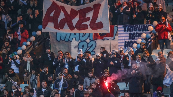 Racing fans display a banner in tribute to Anthony Foley