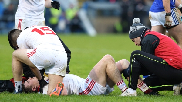 Conor McAliskey lies injured on the Breffni Park turf