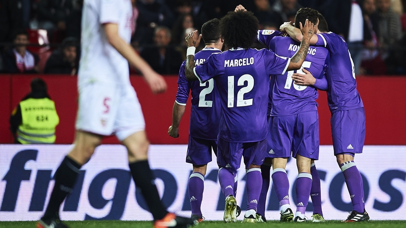 Real Madrid players celebrate the all-important goal to snatch a draw and set the 40-game record