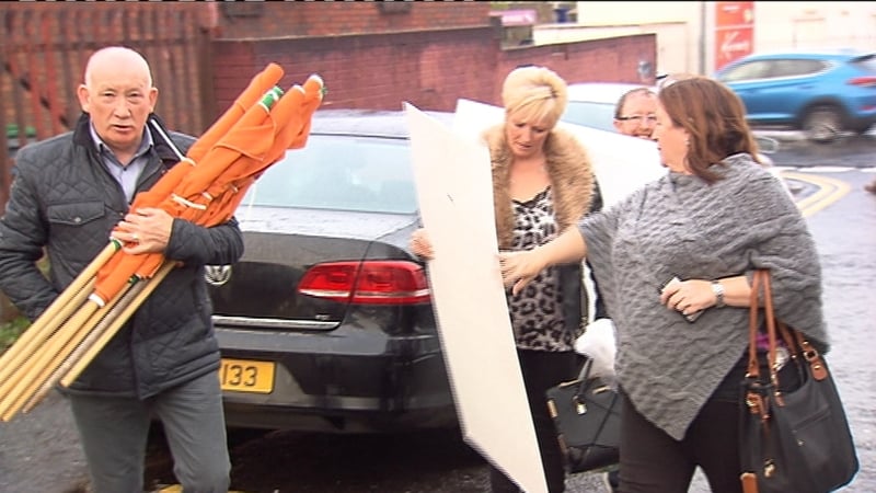 Sinn Féin activists are seen with new posters to be used during the election campaign