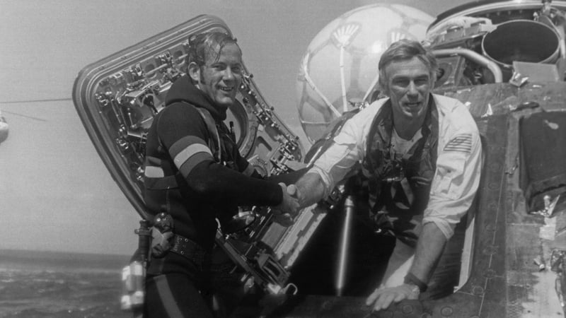 Eugene Cernan, Commander of the Apollo 17 lunar mission, is welcomed back to Earth by a US Navy Pararescueman