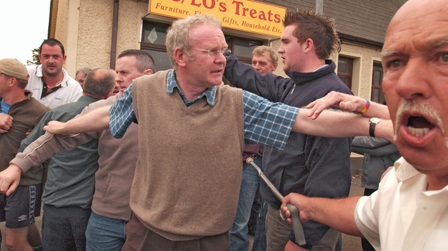 McGuinness tries to calm people as police remove protesters during 12 July events in Dunloy in 2005