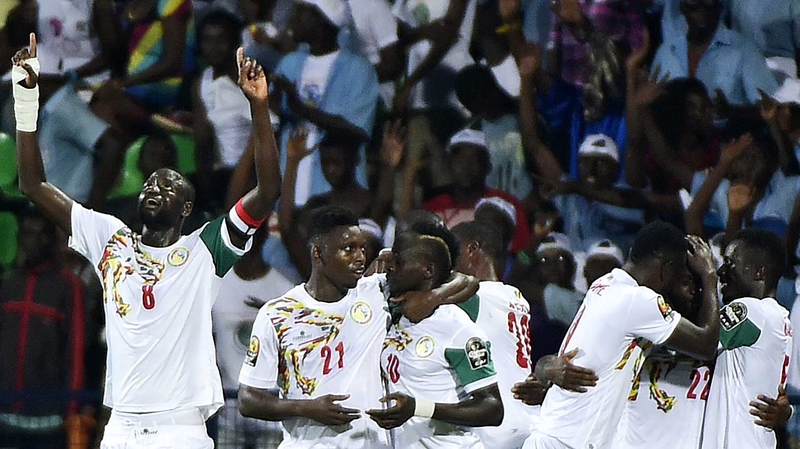 Senegal players swamp Sadio Mane (C) after his goal