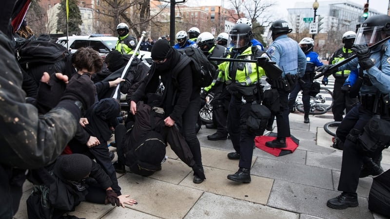 Police officers push a group of demonstrators back before the inauguration in Washington