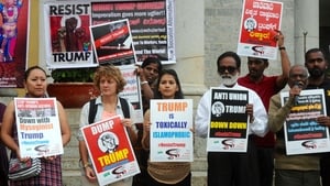 Socialists hold placards and shout slogans against Donald Trump in Bangalore, India