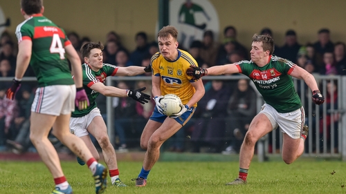 Enda Smith tackled by Fergal Boland and Cillian O'Connor