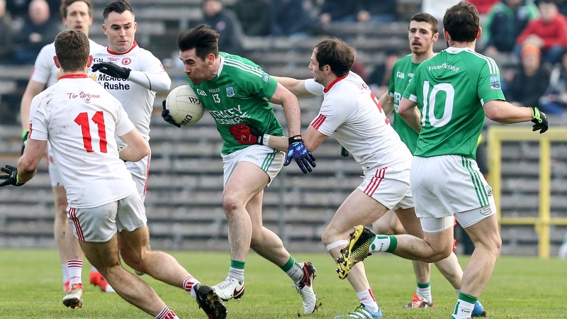 Barry Mulrone of Fermanagh is tackled by Ronan McNabb of Tyrone