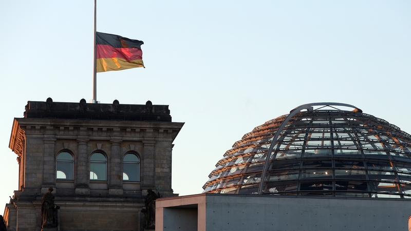 The German flag flies at half mast on the Reichstag building housing the Bundestag