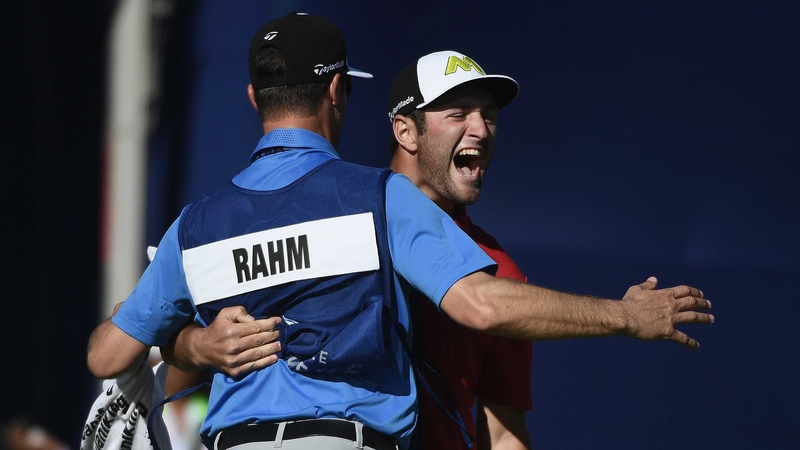 Jon Rahm celebrates victory with his caddie