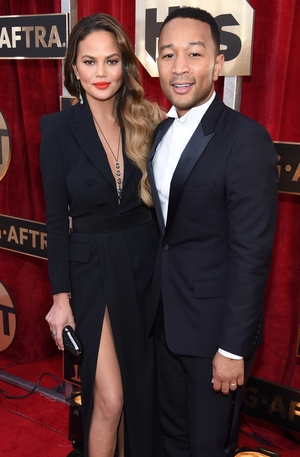 Someone had to rock the thigh-high split tradition and this time it's Chrissy Teigen with hubby John Legend.