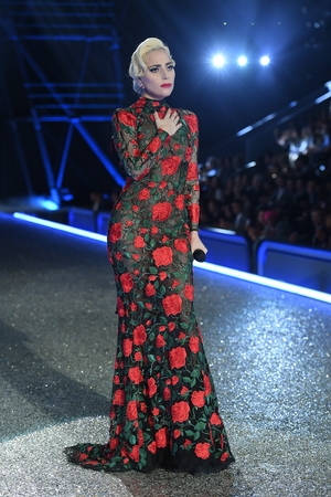 2. Gaga wearing a gorgeous Sicilian-like YolanCris dress at the 2016 Victoria's Secret Fashion Show. She completed the look with a wavy hair bun.