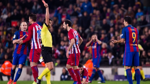 Suarez is dismissed for an elbow on Atletico midfielder Koke