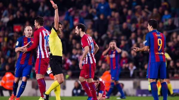 Suarez is dismissed for an elbow on Atletico midfielder Koke
