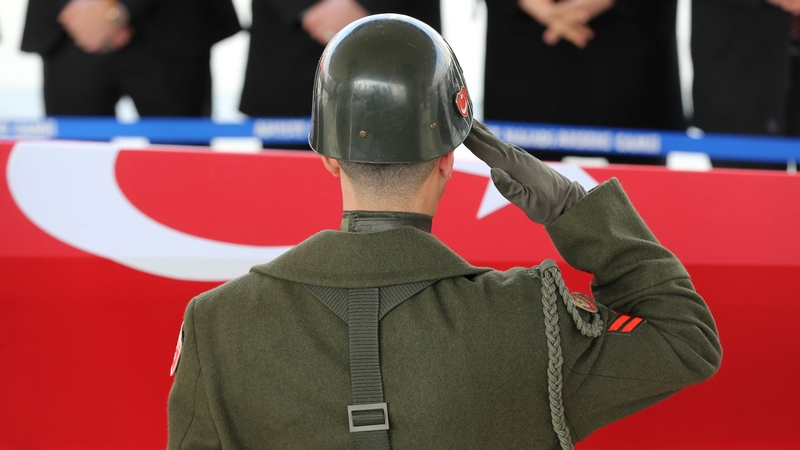 A military honour guard salutes in front of the coffin of one of five Turkish soldiers killed in an attack by IS militants near al-Bab this week
