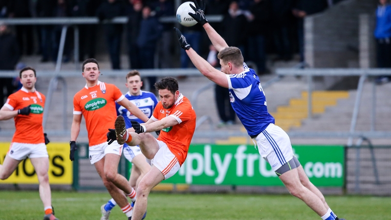 Denis Booth blocks down Armagh's Oisin Mac Iomhair