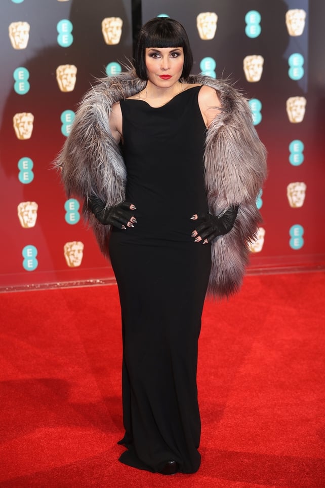 Actress Noomi Rapace went all out with her red carpet look with a twneties style bob and fur stole.