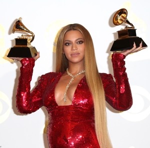 Another stunning Peter Dundas. Beyoncé dress emphasis her twin-baby bump while holding her twin Grammys!