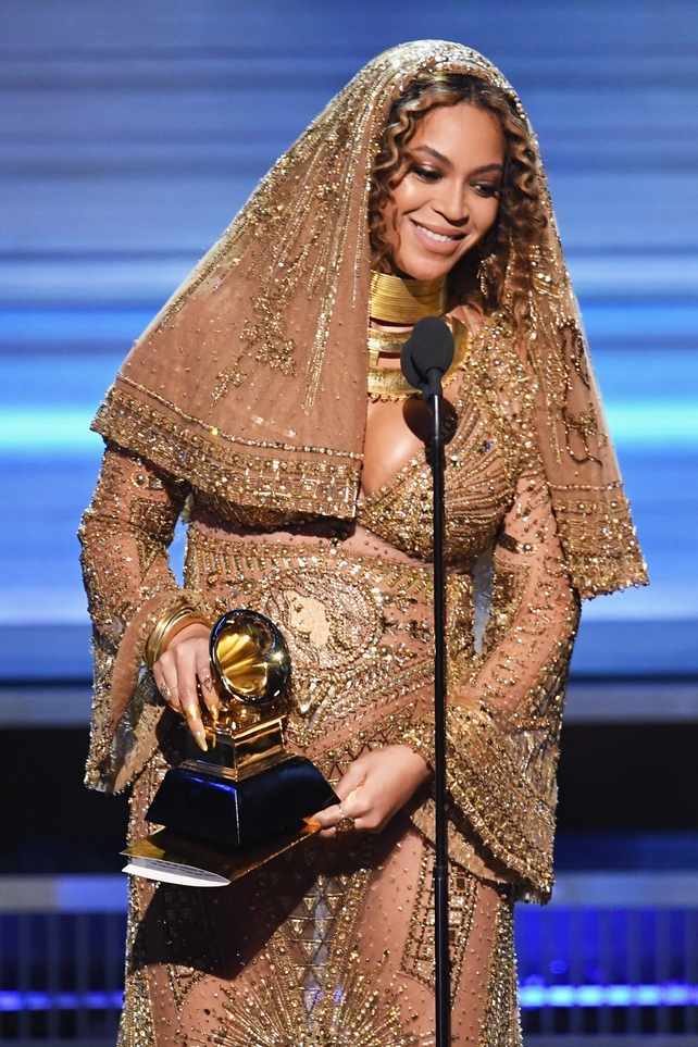 Beyoncé and her bump accepting the Best Urban Contemporary Album award for 'Lemonade'. We've never seen sheer, nude and embellished maternity wear before but we love it.
