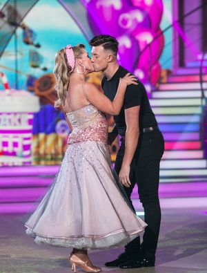 Week 6: Sealed with a kiss! Katherine and Kai quick stepped as Sandy and Danny. We love Katherine's polka dot, pink hair band.