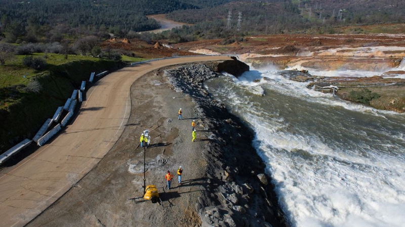 Crews assess the damage to the spillway