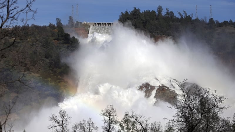 Operators at damaged California dam release water through main spillway
