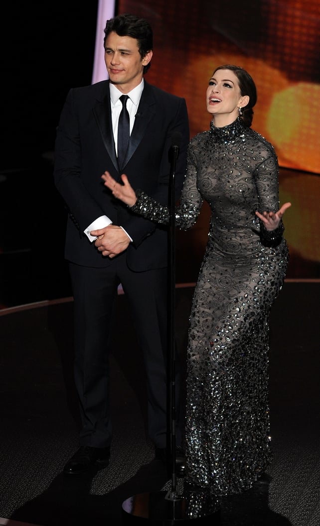Actors James Franco and Anne Hathaway presenting the 83rd the ceremony in 2011. Anne is iconic in a shiny and dark Tom ford gown.