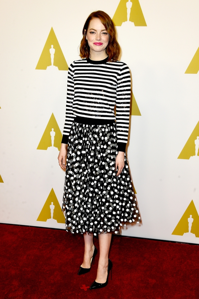 Emma proves you can mix patterns beautifully with this Michael Kors striped sequined jersey and polka dot skirt at the Nominees Luncheon in 2015.