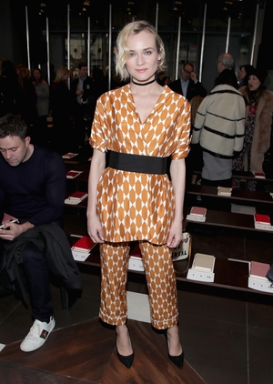 February 14th Day 6: Actress Diane Kruger looking chic and cool in a satin ensemble at the Tory Burch fashion show.