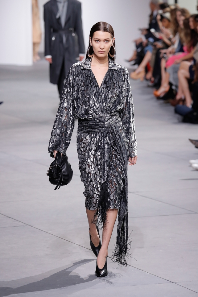 February 15th Day 7: Bella Hadid was everywhere! She walked in Michael Kors fashion show, wearing big earrings and velvet fringed dress. Never too much for Bella!