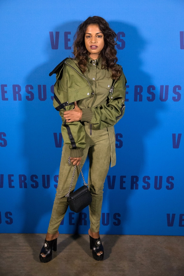 Singer M.I.A. in a khaki ensemble attending the Versus fashion show.