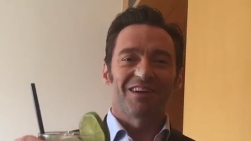 Hugh Jackman raises a glass after his recent treatment for skin cancer
