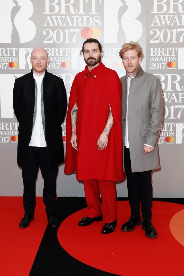 Ben Johnston, Simon Neil and James Johnston of Biffy Clyro. That red cape is certainly eye catching...