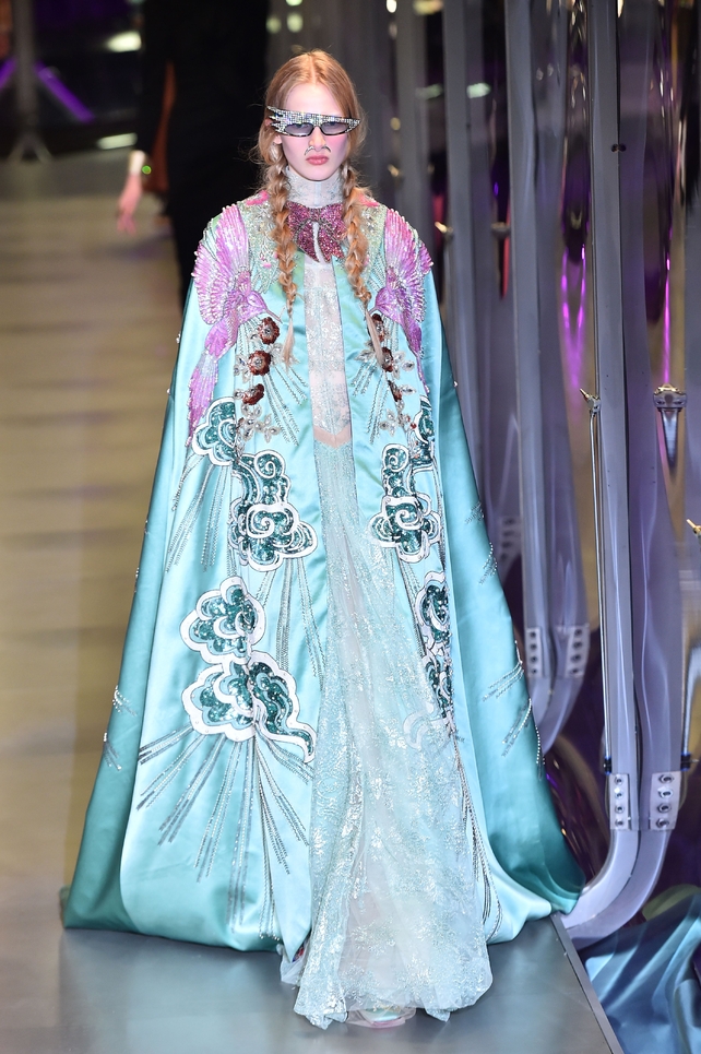 Magnificent silk and embroidered cape at the Gucci fashion show complete with funky sunglasses.