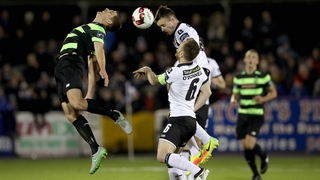 Dundalk's Robbie Benson and David McAllister of Rovers rise for a header